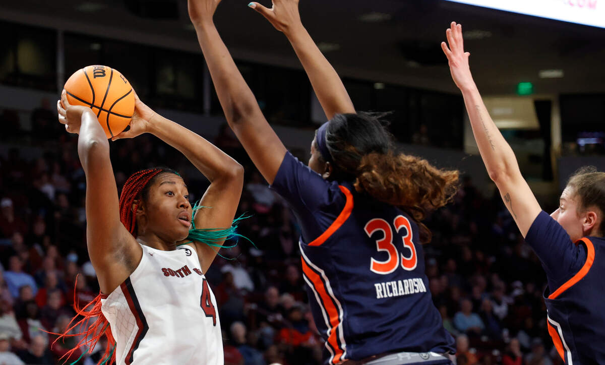South Carolina’s Aliyah Boston (4) looks to pass as Auburn’s Kharsyssa Richardson (33) and Romi Levy (11) pressure during the first half of action in the Colonial Life Arena on Thursday, Dec. 5, 2023.