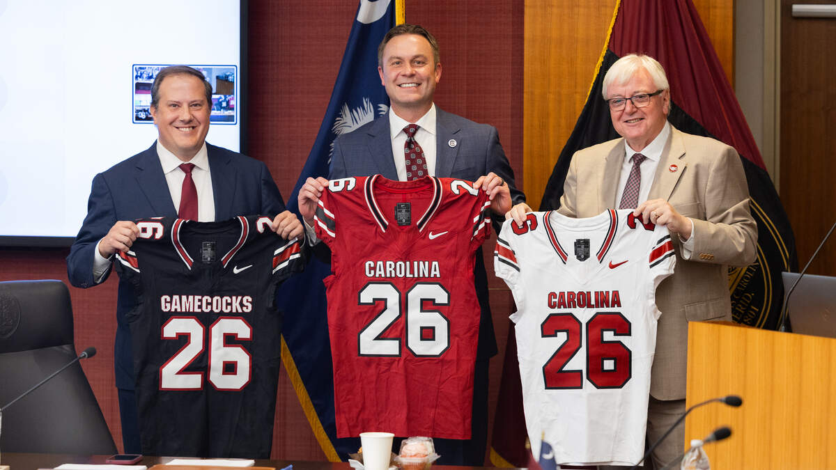 From August 2025: South Carolina leaders show off Nike-branded Gamecock football jerseys, from left: Thad Westbook, USC board chair; Jeremiah Donati, athletics director; and Michael Amiridis, school president.