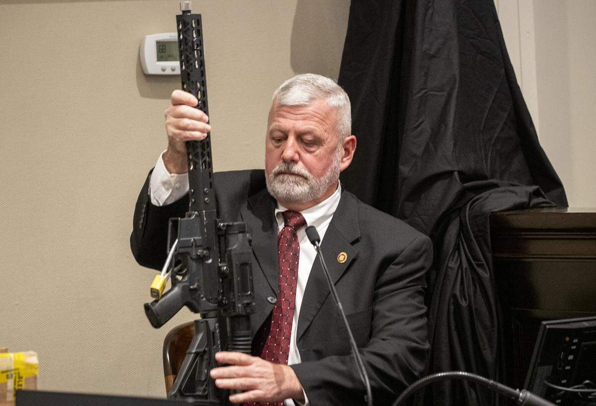 SLED special agent Jeff Croft inspects a 300 Blackout AR-15 style rifle with an infrared scope taken purchased by Alex Murdaugh for his sons.