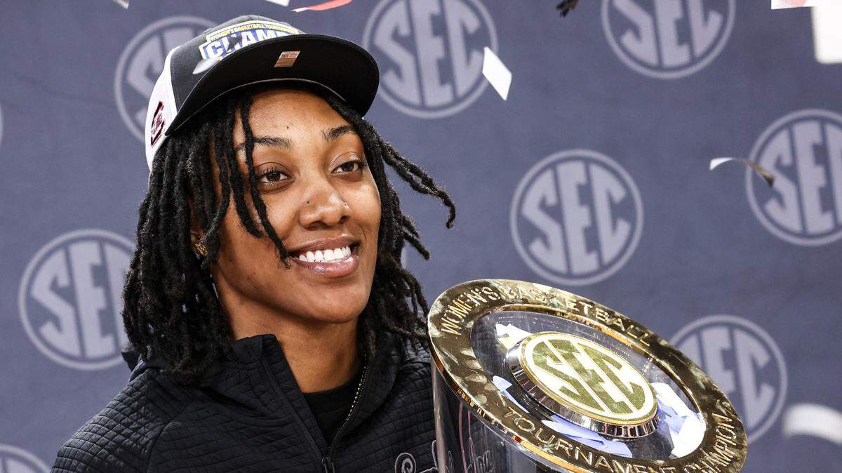 University of South Carolina’s Ashlyn Watkins (2) poses with the SEC Tournament trophy after the Gamecocks won the Tournament at the Bon Secours Wellness Arena in Greenville on Sunday, March 9, 2025.