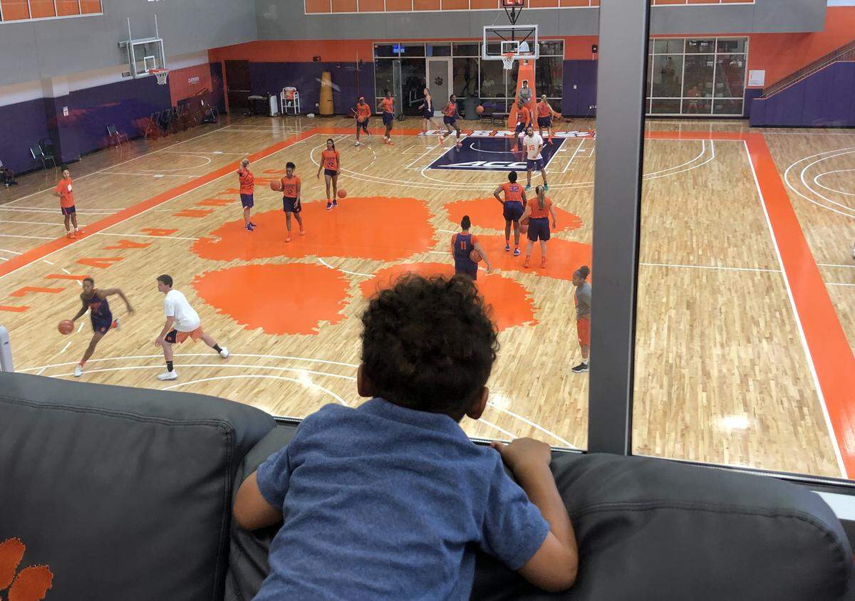 Nehemiah Butler looks on from Amanda Butler’s office during a Clemson practice.