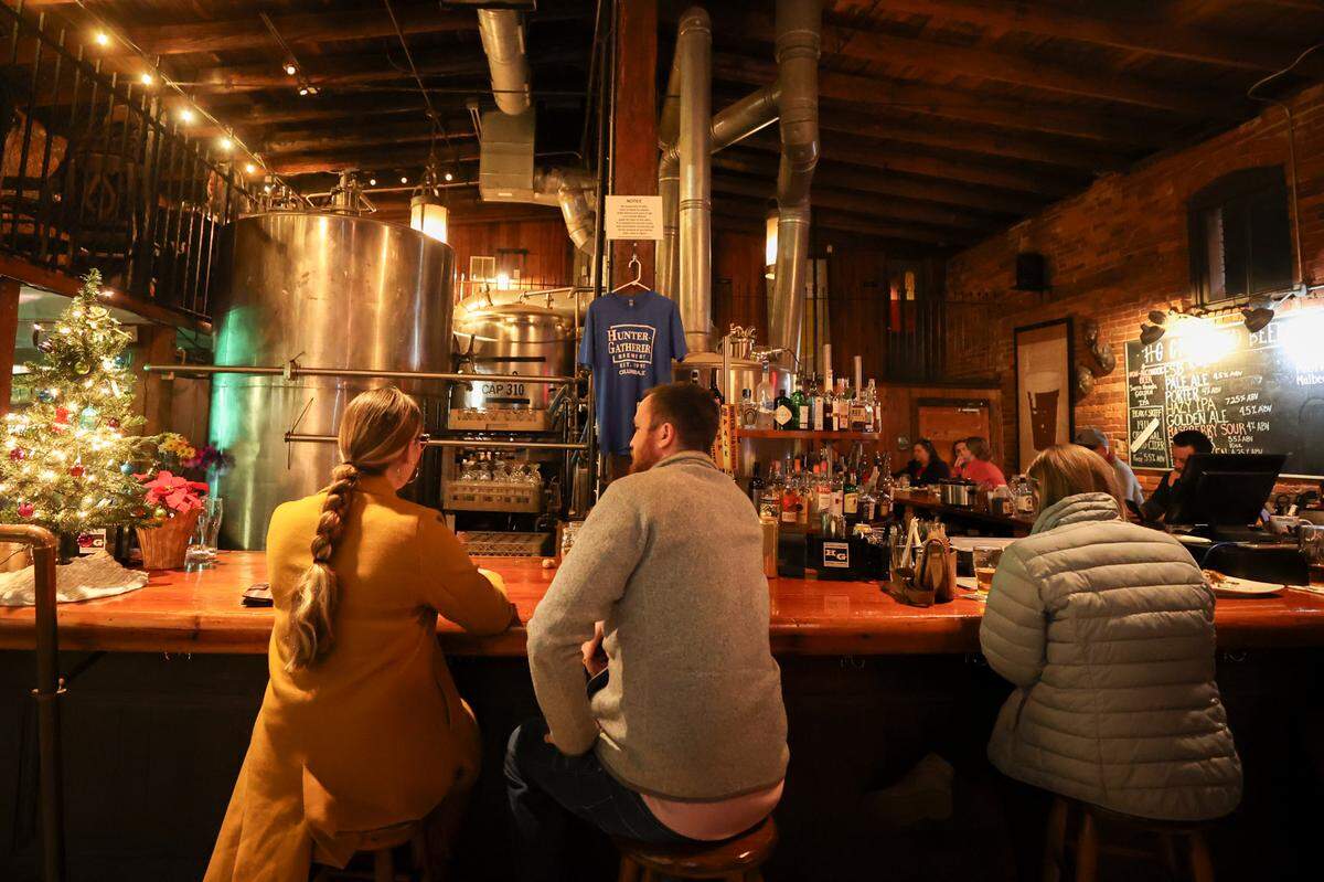 Patrons enjoy dinner and drinks at Hunter Gatherer in Columbia on Thursday Dec. 12, 2024. Hunter Gatherer opened in 1995 as Columbia’s first microbrewery.