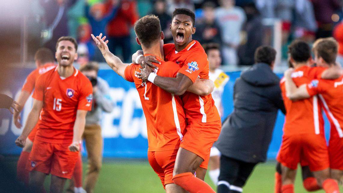 Clemson’s Isaiah Reid, center right, celebrates with Ben Erkens (2) after defeating Washington in the NCAA college soccer tournament championship in Cary, N.C., Sunday, Dec. 12, 2021. (AP Photo/Ben McKeown)