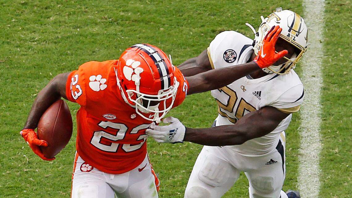 Clemson running back Lyn-J Dixon (23) pushes Georgia Tech linebacker Charlie Thomas (25) away during second-quarter action in Clemson, S.C. on Saturday, Sept. 18, 2021.