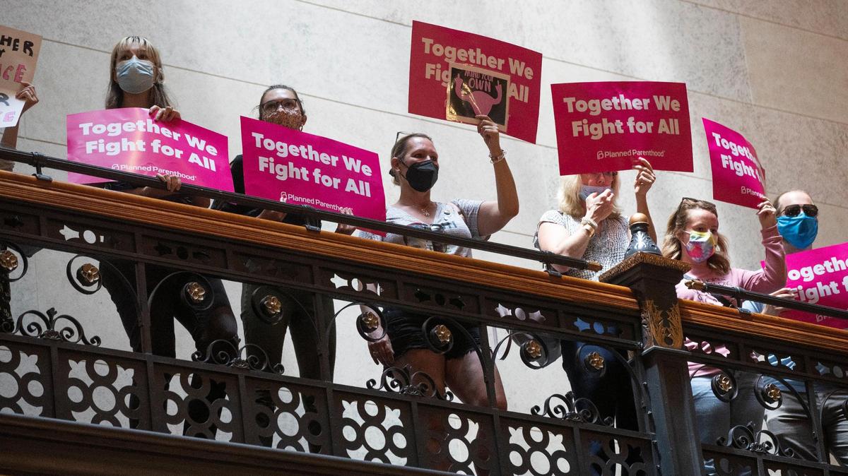 Protesters who support abortion access hold signs in the South Carolina State House lobby on Tuesday, June 28, 2022.