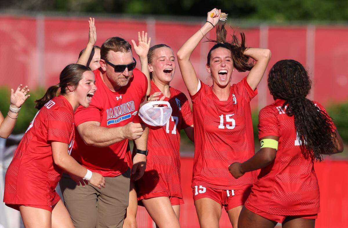 Head coach Ryan Brewer of Hammond and teammates celebrate a goal by Logan Rivers (12) during Hammond’s match against Hilton Head Christian in Columbia on Tuesday, May 6, 2025.