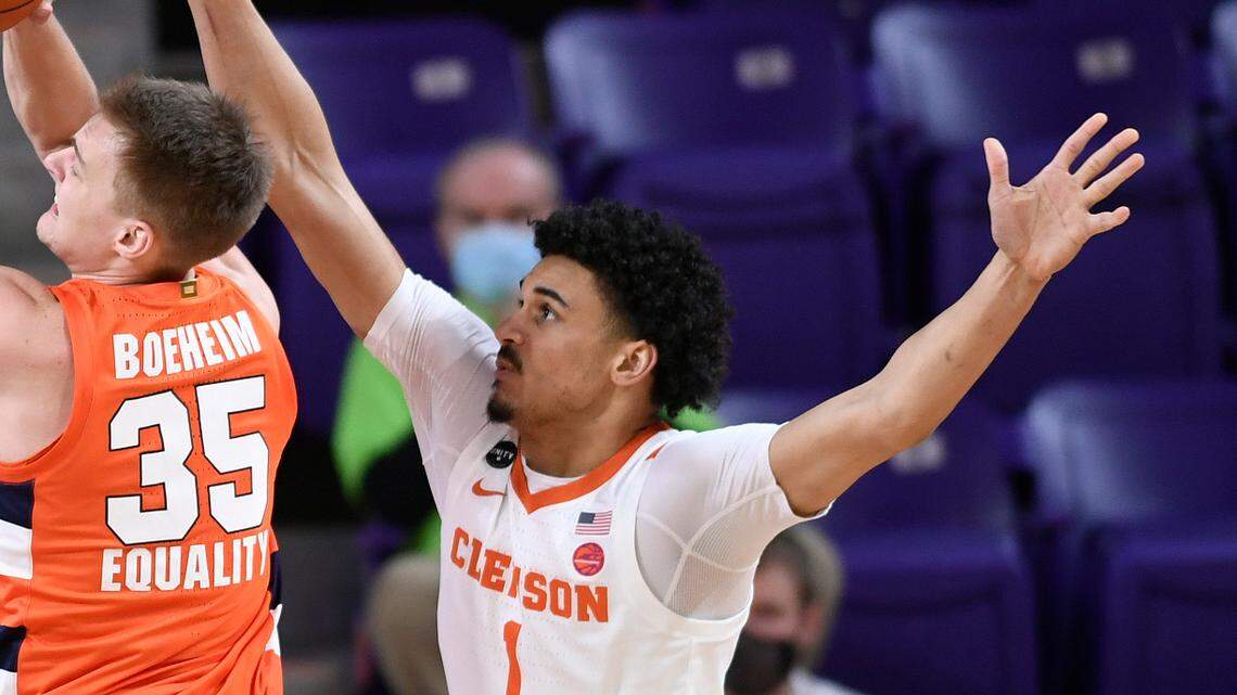 Syracuse guard Buddy Boeheim (35) shooters between Clemson guard Clyde Trapp (0), left, and forward Jonathan Baehre (1) during first half action at Clemson’s Littlejohn Coliseum Saturday, February 6, 2021.
