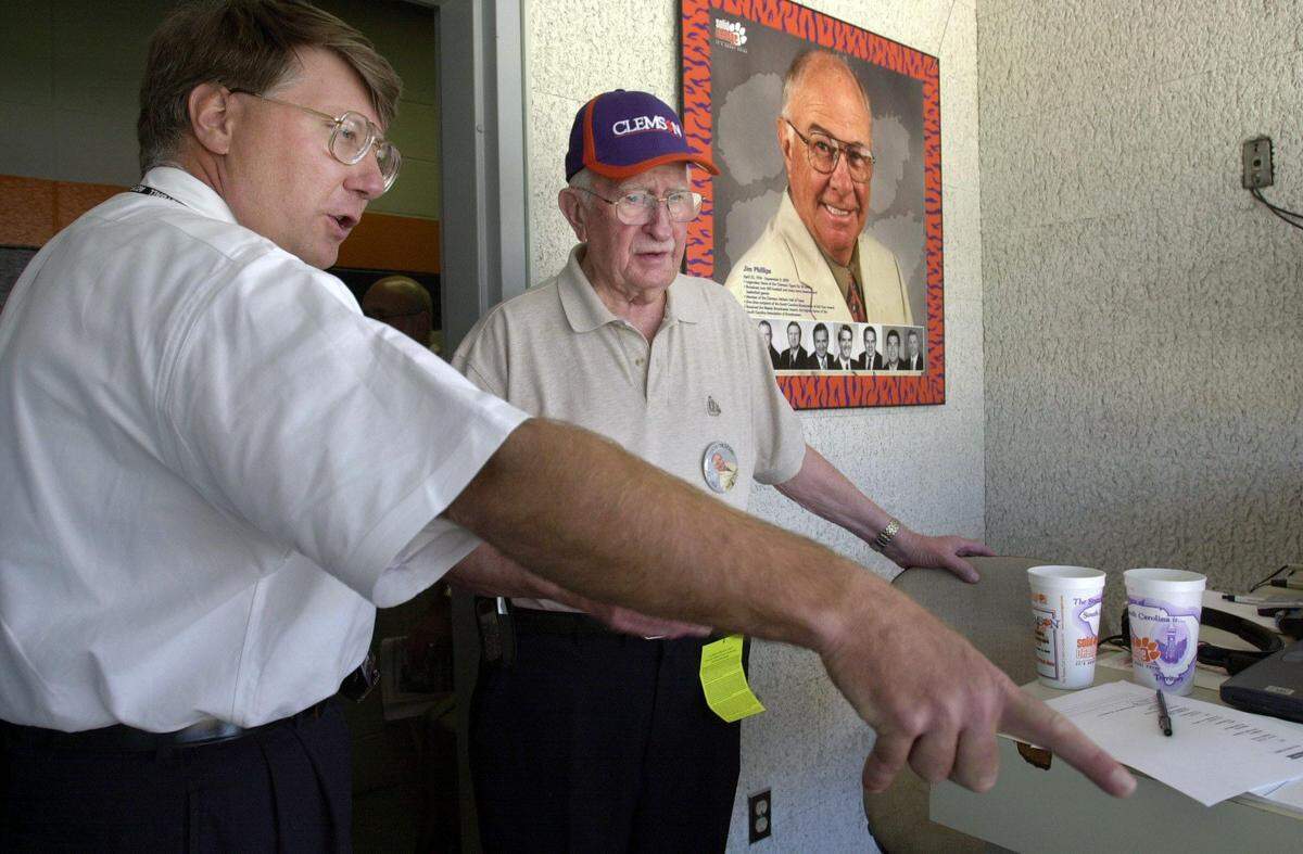 From Sept. 13, 2003: Clemson sports information director Tim Bourret talks with former voice of the Gamecocks Bob Fulton in the home radio booth at Memorial stadium  before the Clemson-Middle Tennesee State game. Bourret would call most of the game, giving up the microphone to the late Fulton for the first Clemson offensive series of the second quarter as a tribute to the late Jim Phillips. Phillips passed away earlier that week. Bourret and Fulton were asked by Phillips' family to call the game in his honor.