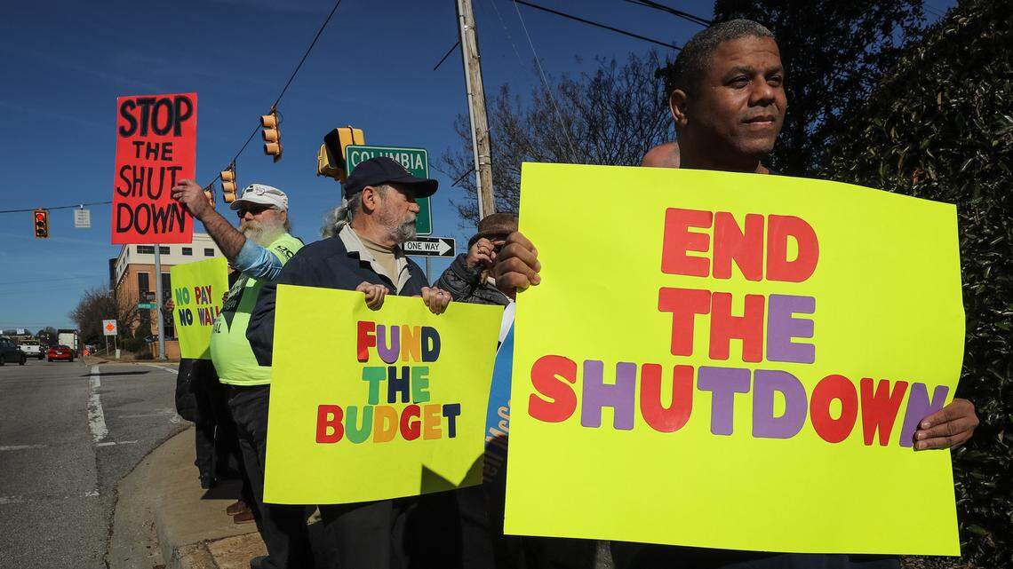 Gary Votour, Johnny Allen and Tony Howell protest federal workers being furloughed due to government shutdown outside Lindsay Graham’s Columbia office 1/10/19.