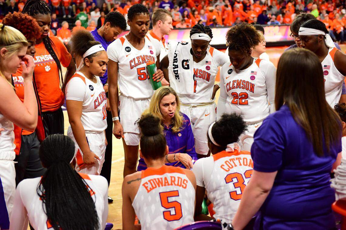 Clemson head coach Amanda Butler, center, speaks to her team during their game against Notre Dame.