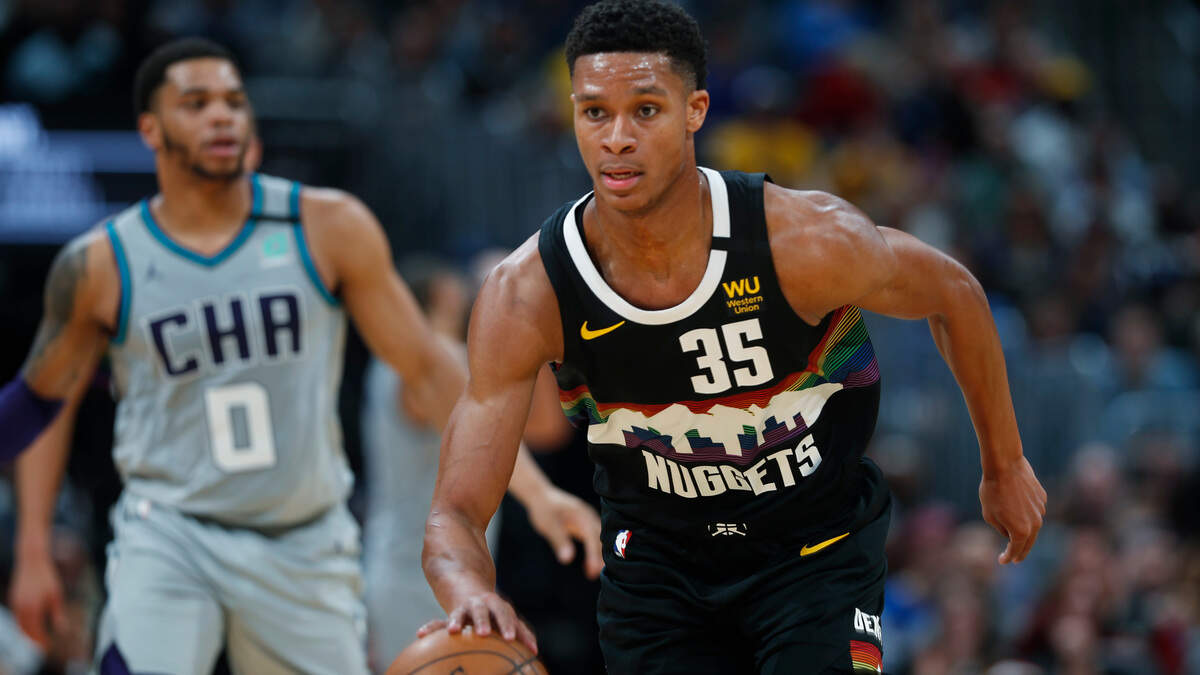 Denver Nuggets guard PJ Dozier, front, brings the ball up as Charlotte Hornets forward Miles Bridges trails during the second half of an NBA basketball game Wednesday, Jan. 15, 2020, in Denver. The Nuggets won 100-86. (AP Photo/David Zalubowski)