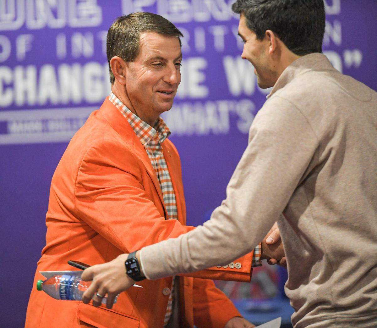 Clemson Head Football Coach Dabo Swinney shakes hands with Director of Athletics Graham Neff talks during a press conference in Clemson, S.C. Wednesday, February 2, 2022.