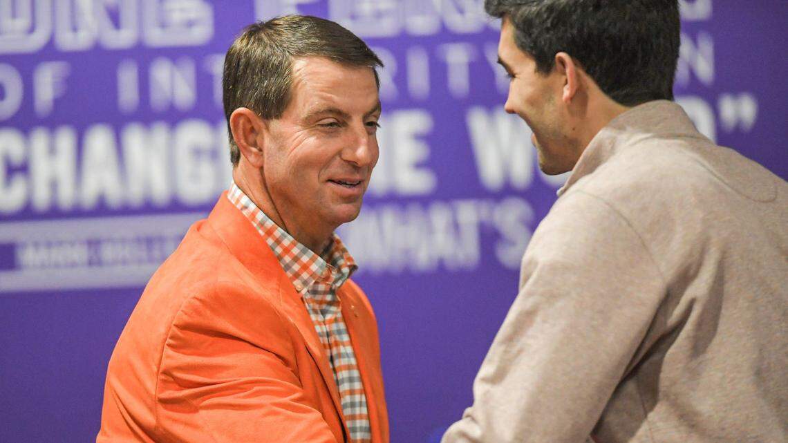 Clemson Head Football Coach Dabo Swinney shakes hands with Director of Athletics Graham Neff talks during a press conference in Clemson, S.C. Wednesday, February 2, 2022.