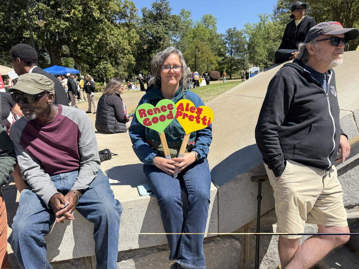 Jennifer Duffy of Columbia held signs commemorating Renee Good and Alex Pretti, two activists shot to death by Trump Administration ICE agents in controversial circumstances. 
