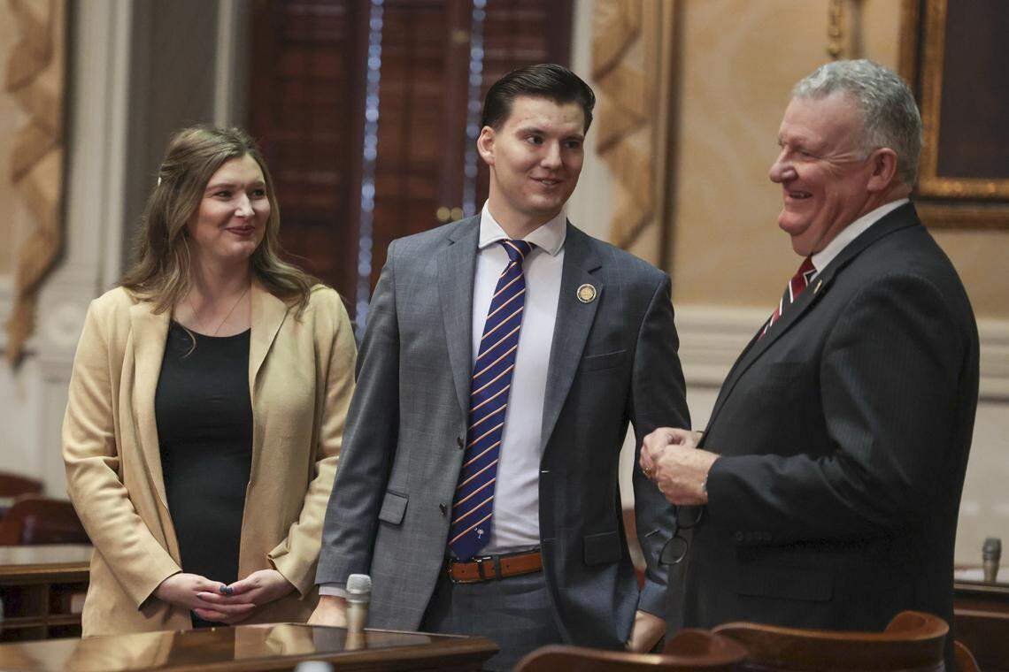 State Rep. Luke Rankin (center) and his wife Hope Rankin speak with House staffer Richard Pearce on the floor of the South Carolina House of Representatives on Tuesday, Dec. 3, 2024.
