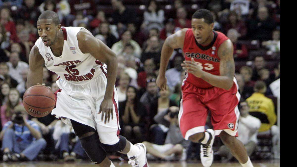 Malik Cooke (15) heads down the court after retrieving a loose ball.