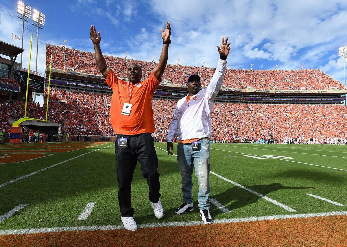 Former Clemson greats CJ Spiller, left, and James Davis wave to the crowd during the 1st quarter Saturday, October 20, 2018 at Clemson’s Memorial Stadium. Clemson Nc State Football
