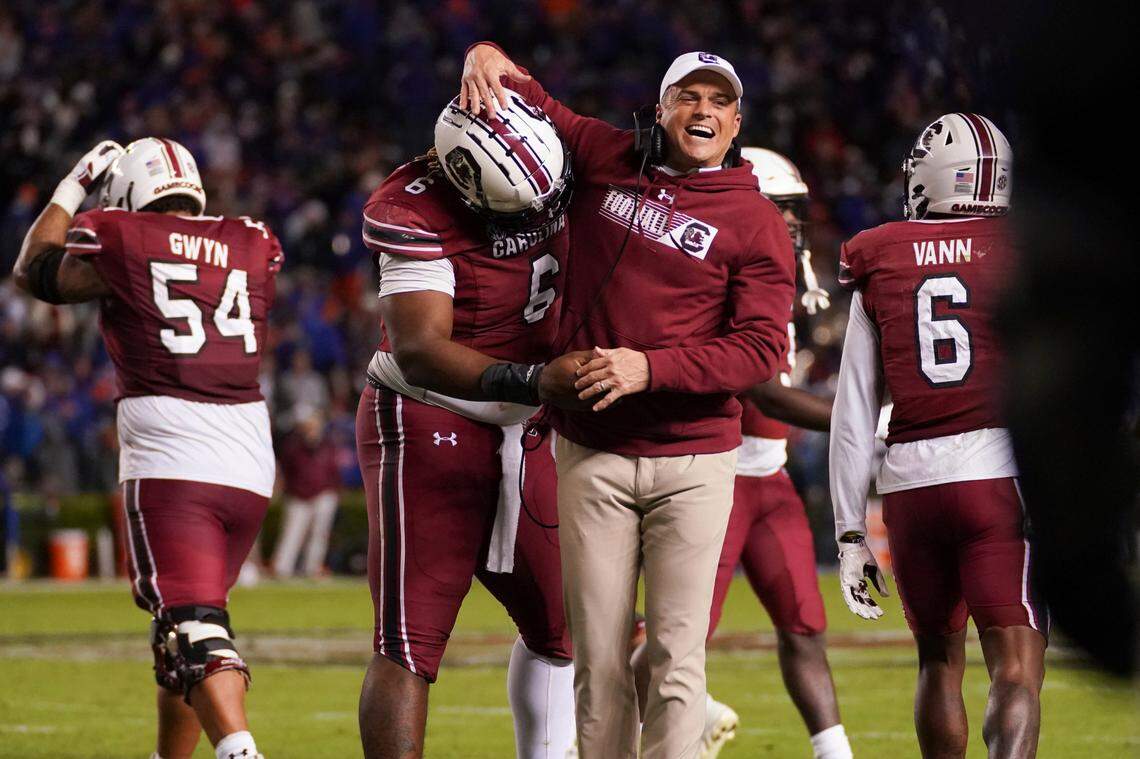 South Carolina coach Shane Beamer celebrates a defensive stop with Zacch Pickens (6) during the second half of the team’s NCAA college football game against Florida on Saturday, Nov. 6, 2021, in Columbia, S.C. (AP Photo/Sean Rayford)