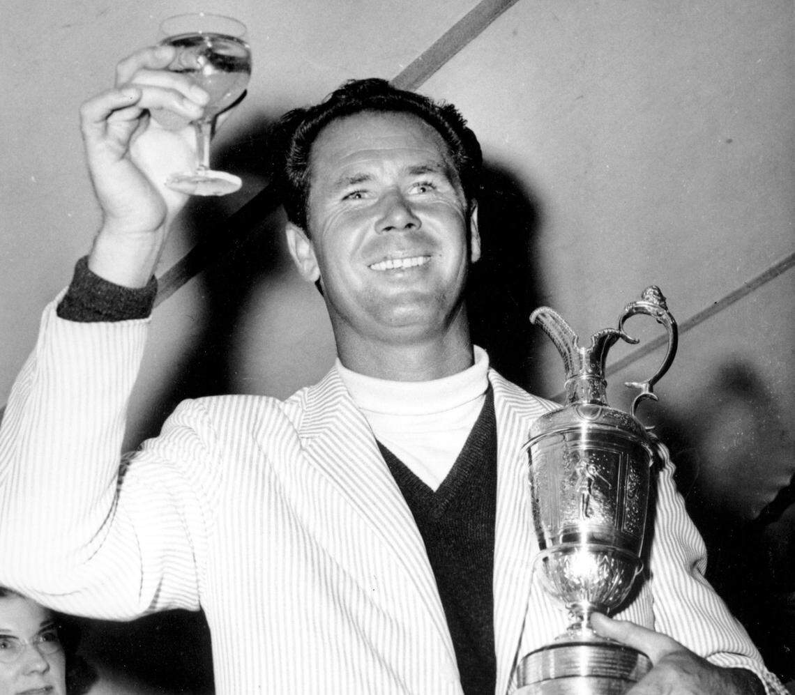 July 10, 1964: Tony Lema holds a glass of champagne and his trophy after winning the British Open Golf Championship at St. Andrews, Scotland.