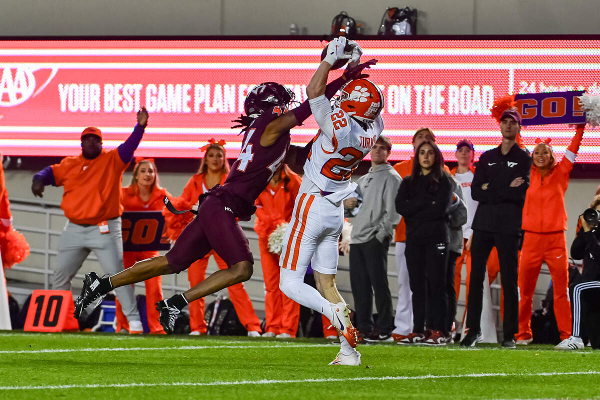 Nov 9, 2024; Blacksburg, Virginia, USA; Clemson Tigers wide receiver Cole Turner (22) catches a touchdown pass while being defended by Virginia Tech Hokies cornerback Dorian Strong (44) during the third quarter at Lane Stadium.
