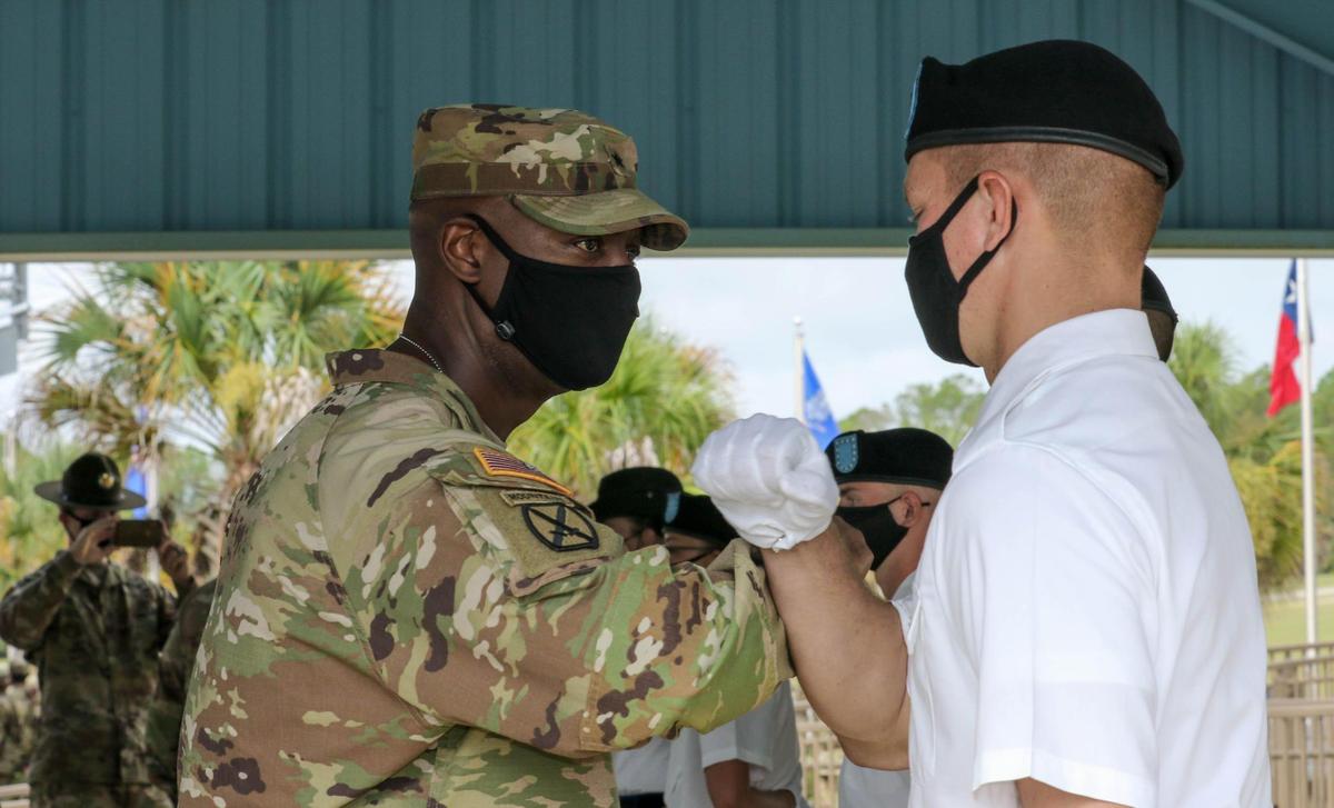 Brig. Gen. Milford Beagle Jr. greets Pvt. Austyn Walker by bumping arms after graduation at Fort Jackson. 9/10/20