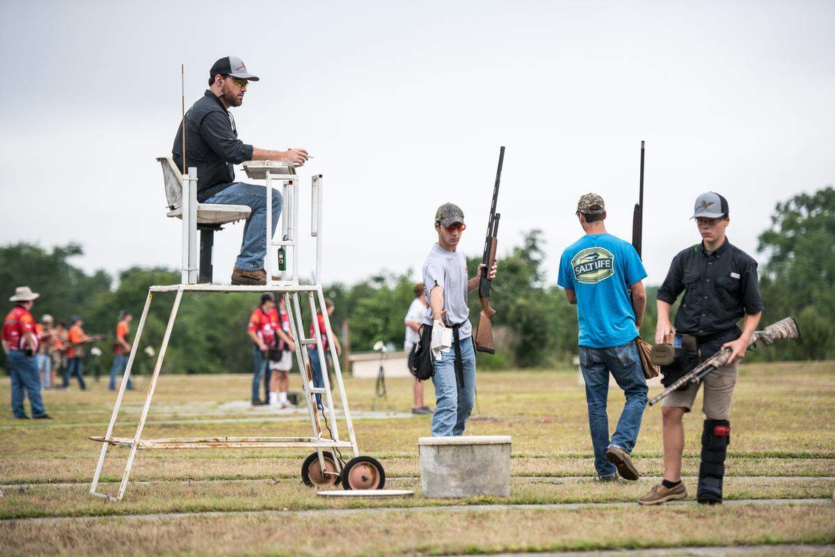 A scorer sits on his perch as competitors toss away empty shell boxes at the Mid-Carolina Gun Club during the South Carolina State High School Clay Target League championships Saturday, June 8, 2019, in Orangeburg, S.C.