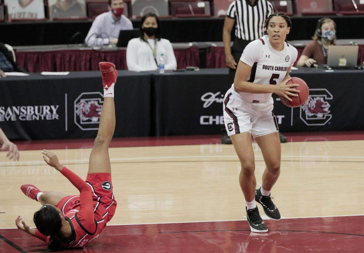 Georgia Lady Bulldogs forward Jordan Isaacs (20) falls as South Carolina Gamecocks forward Victaria Saxton (5) gets ready to shoot at Colonial Life Arena on Thursday, January 21, 2021.