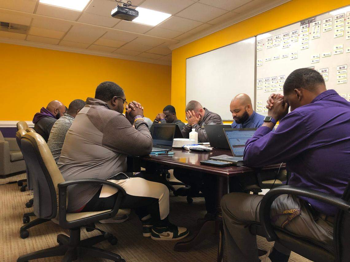 Benedict College’s football staff joins in prayer before a staff meeting on Wednesday, Nov. 2, 2022.