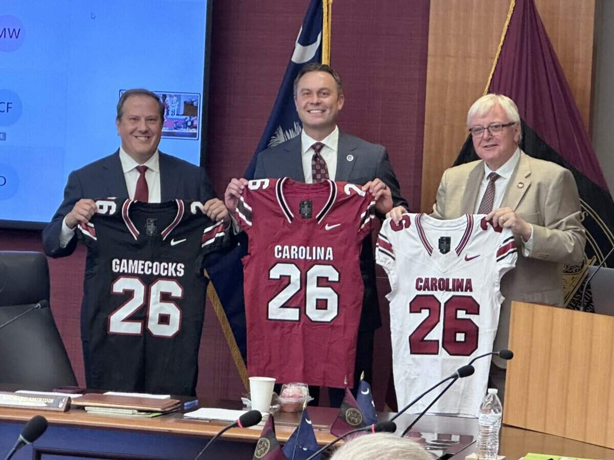 South Carolina leaders show off Nike-branded Gamecock football series, from left: Thad Westbook, USC board chair; Jeremiah Donati, athletics director; and Michael Amiridis, school president.