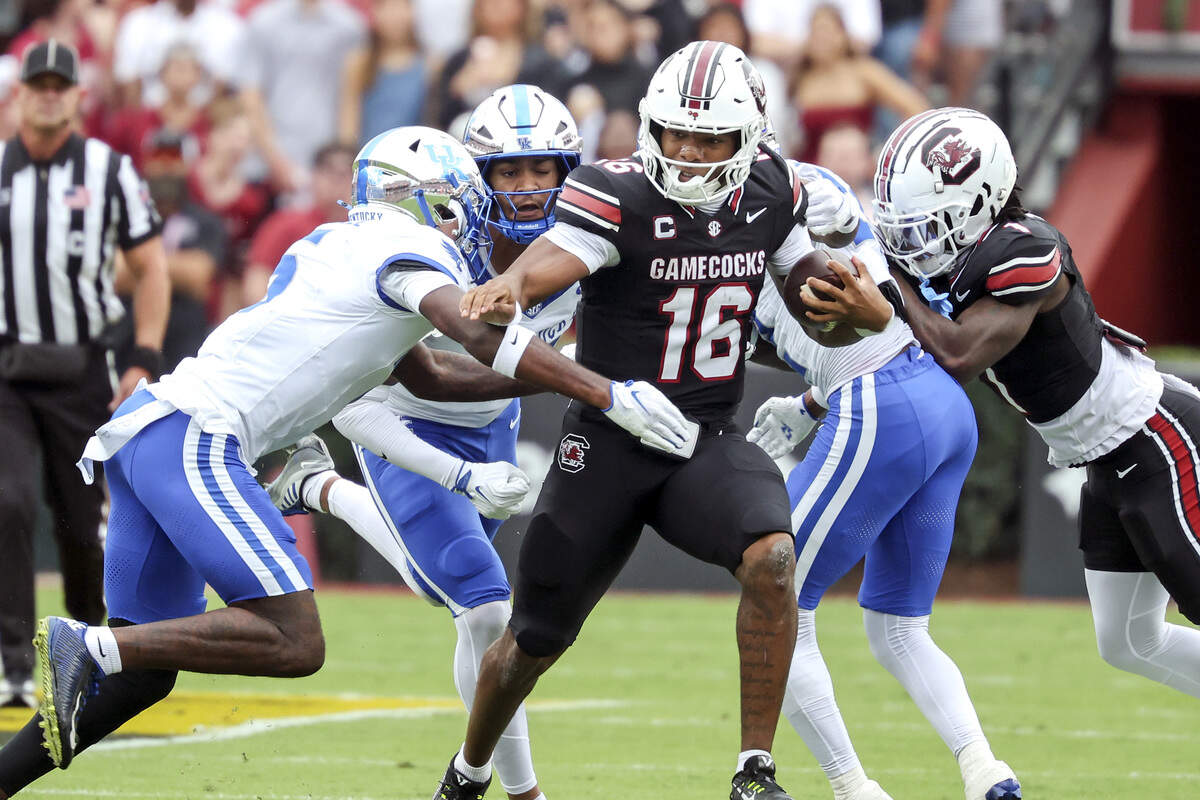 fb1-0350.jpg South Carolina's LaNorris Sellers (16) evades Kentucky defenders during the first half of South Carolina’s game against Kentucky at Williams-Brice Stadium in Columbia on Saturday, Oct. 3, 2026.