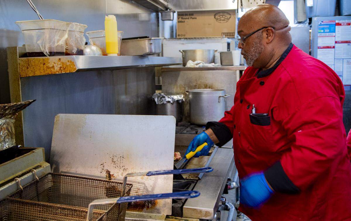 Mike Chestnut prepares orders in the kitchen at Big Mike’s Soul Food in Myrtle Beach. Chestnut, who owns the restaurant, spoke with the Sun News Tuesday afternoon about how the coronavirus pandemic has affected his business.