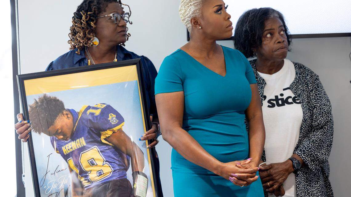 Adrien Lake-Watson, center, her mother Janice Lake, left, with a photo of Julian Keel and mother in law Patricia Bellamy, participate in a press conference with lawyers Bakari Sellers and Pete Strom on October 4, 2024.