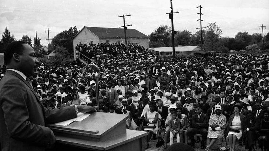 Martin Luther King Jr. delivers an address at the Tomlinson High School athletic field in Kingstree, South Carolina, to encourage voter participation in upcoming elections in this 1966 file photo.