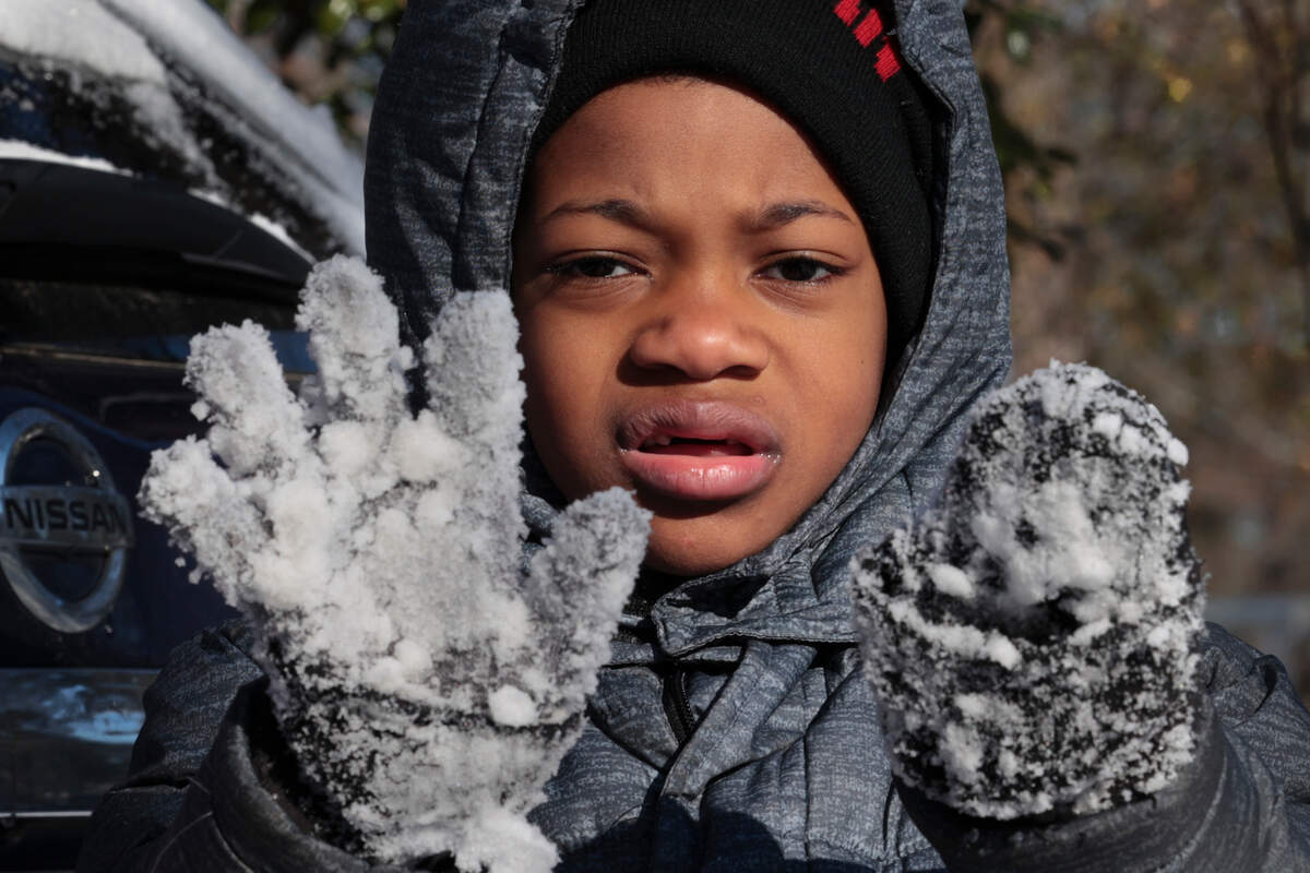 Declan Cohen, has snow covered gloves after begging to go out and play in the snow in the South Kilbourne neighborhood. It was the 6-year-olds first time to play in the snow on Wednesday, Jan. 22, 2025.