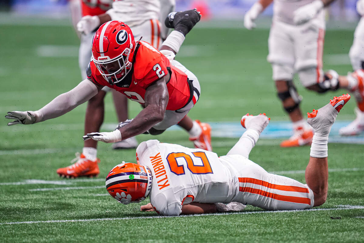 Aug 31, 2024; Atlanta, Georgia, USA; Georgia Bulldogs linebacker Smael Mondon Jr. (2) flies over Clemson Tigers quarterback Cade Klubnik (2) during the second half at Mercedes-Benz Stadium. Mandatory Credit: Dale Zanine-USA TODAY Sports