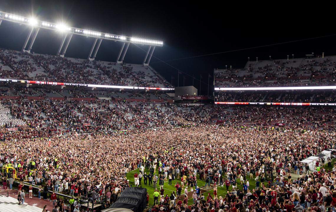 Nov 2, 2024; Columbia, South Carolina, USA; South Carolina Gamecocks students rush the field following their win over the Texas A&M Aggies at Williams-Brice Stadium. Mandatory Credit: Jeff Blake-Imagn Images