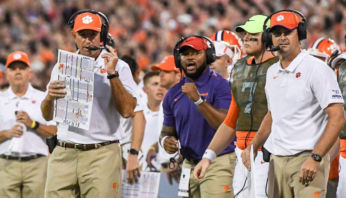 Clemson Head Coach Dabo Swinney, left, and wide receiver coach Jeff Scott, right, on the sideline playing Georgia Tech during the first quarter at Memorial Stadium in Clemson Thursday, August 29, 2019.