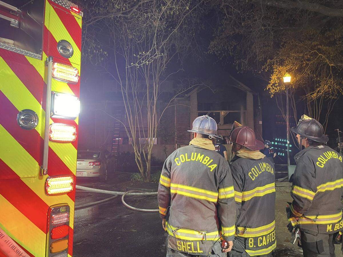 Members of the Columbia Fire Department respond to a burning apartment building.