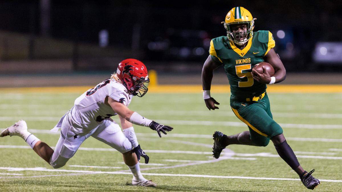 Spring Valley Vikings Evan Javis (5) gets around Nation Ford Falcons Jackson Sims (33).