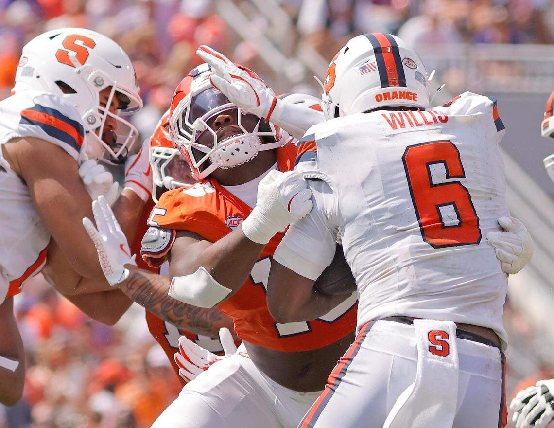 Clemson defensive end Jahiem Lawson (15) is pushed back by Syracuse running back Yasin Willis (6) during Saturday’s game.