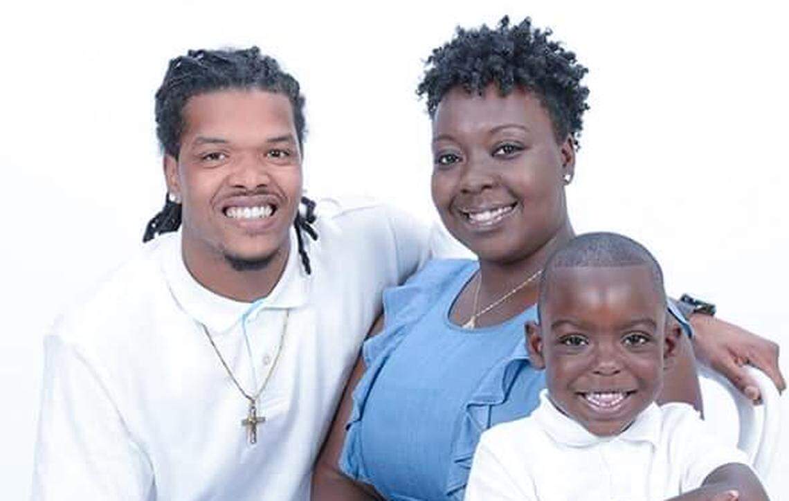 Sinetra Geter-Johnson poses for a family photo with her husband, Jah Johnson, and son Kamrin in 2017.