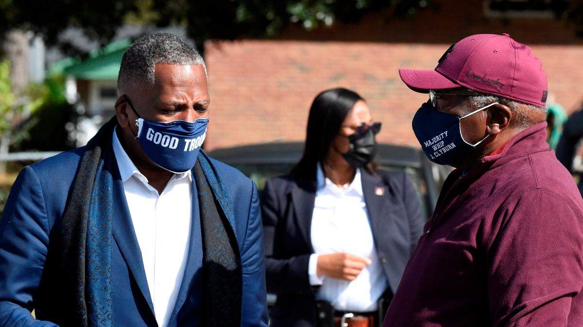 Steve Benjamin, mayor of Columbia, S.C., left, speaks with U.S. House Majority Whip Jim Clyburn, right, outside a polling place on Tuesday, Nov. 3, 2020, in Columbia, S.C. (AP Photo/Meg Kinnard)