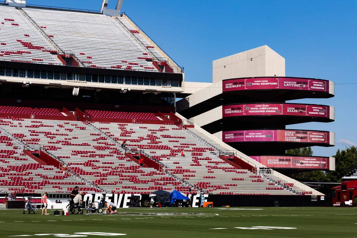 Workers at the University of South Carolina paint the field at Williams-Brice Stadium on Friday, September 12, 2025.