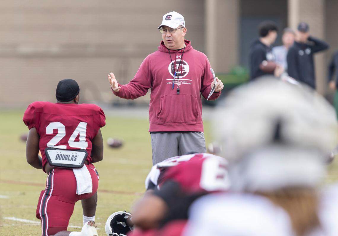 South Carolina associate head coach Pete Lembo speaks with running back Mario Anderson (24) during the Gamecocks’ practice in Columbia on Thursday, March 23, 2023.