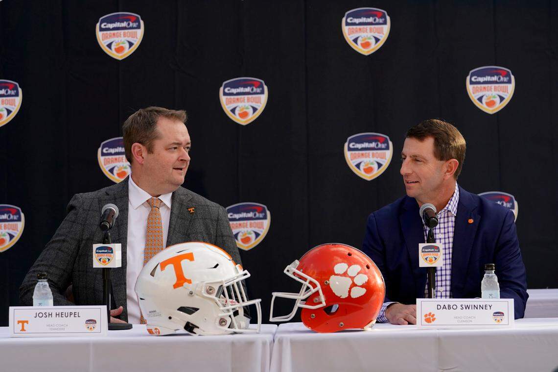 Tennessee head coach Josh Heupel, left, and Clemson head coach Dabo Swinney, right, speak during a news conference for the Orange Bowl NCAA college football game, Wednesday, Dec. 7, 2022, in Hollywood, Fla. The two teams will play in the Orange Bowl on Dec. 30. (AP Photo/Lynne Sladky)