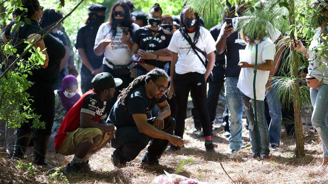 Family of Sanaa Amenhotep and supporters gather in silence on Saturday, May 1, at the place where she was found dead two days earlier in Leesville, South Carolina.