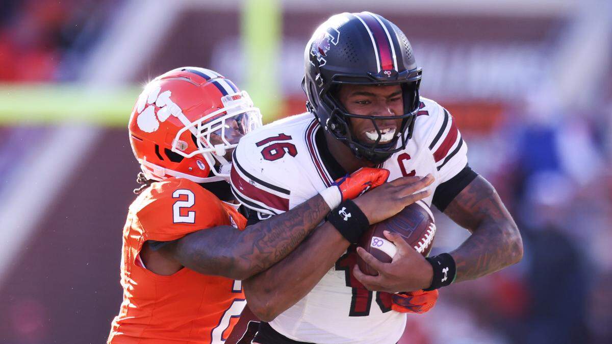South Carolina quarterback LaNorris Sellers (16) fights off the tackle of Clemson cornerback Shelton Lewis (2) during the second half of the Palmetto Bowl between South Carolina and Clemson at Memorial Stadium in Clemson on Saturday, November 30, 2024.
