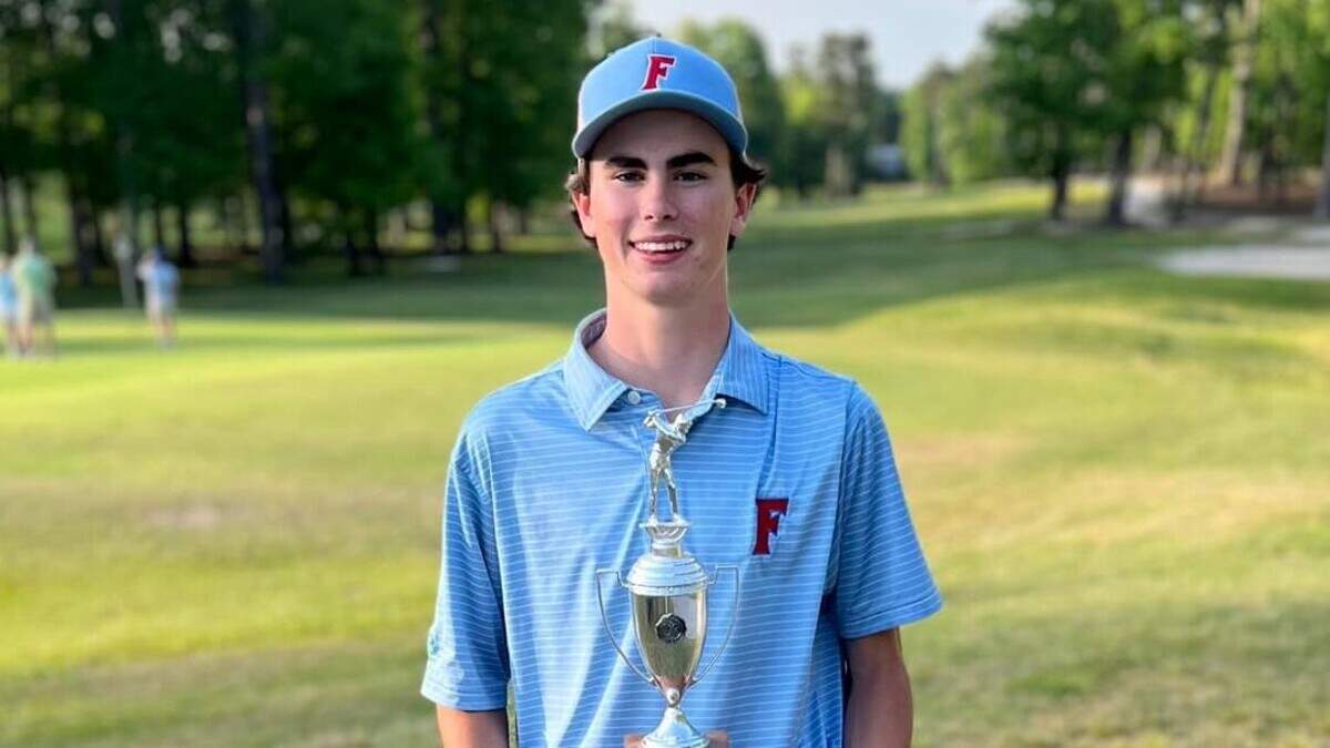 AC Flora’s Burch Harrison holds the trophy after winning the Region 4-4A tournament this year,