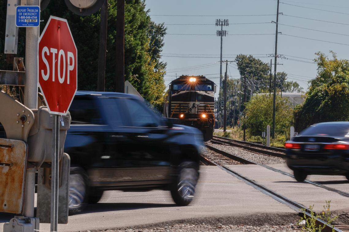 Motorists pass in front of a train before the crossing barricade is lowered at Assembly Street near Whaley Street at one of the 15 railroad crossings on the main Columbia thoroughfare.