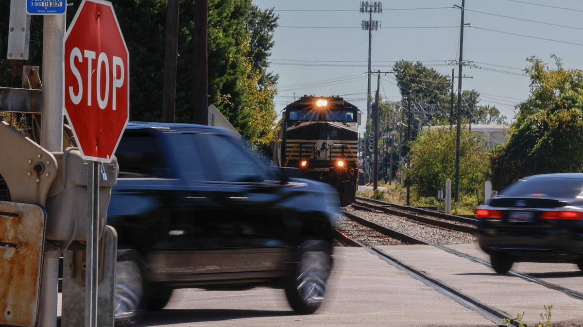 Motorists pass in front of a train before the crossing barricade is lowered at Assembly Street near Whaley Street at one of the 15 railroad crossings on the main Columbia thoroughfare.